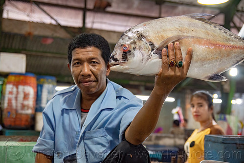 fish merchant showing large fish, fish market, man, pasar pabean, seafood, surabaya, woman