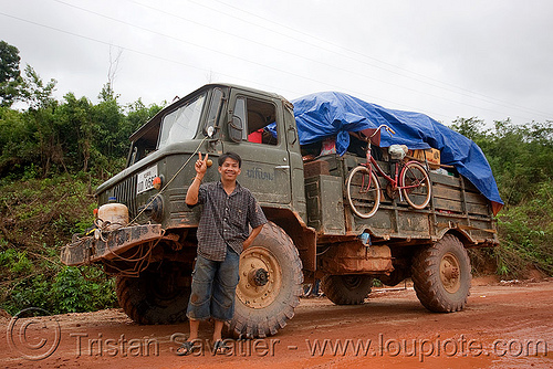 gaz-66 - газ-66 - russian all terrain 4x4 truck (laos), 4x4 trucks, all terrain, army trucks, gaz-66, lorry, man, military trucks, mud, peace sign, road, truck driver, v sign, victory sign, газ-66, го́рьковский автомоби́льный заво́д