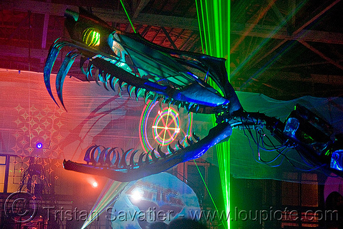 giant snake skeleton animated sculpture - opulent temple massive rave party (treasure island, san francisco) - serpent mother, art installation, fangs, green laser, head, laser lightshow, laser show, lasers, night, nightclub, opulent temple, sculpture, serpent mother, skeleton, snake, teeth