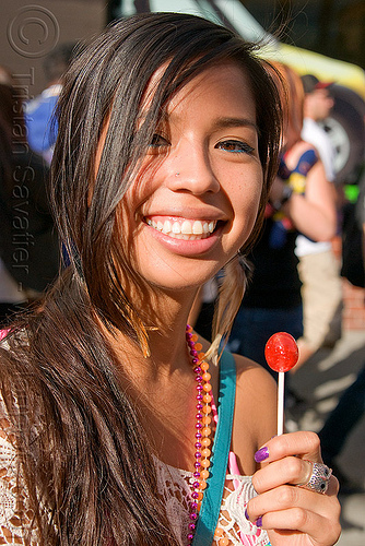 girl holding red lollipop, red lollipop, woman