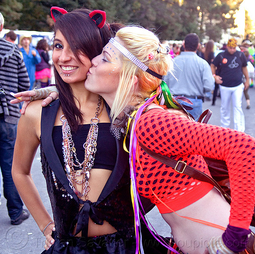 girl kissing girl on the cheek, audreya, blonde, brunette, cat ears hair band, devin, fashion, fishnet top, necklaces, neklace, piercing, ravers, ribbons, women