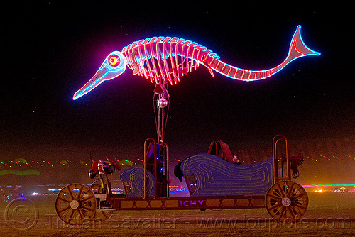 glowing fish - art car, burning man art cars, burning man at night, fish, glowing, mutant vehicles, neon, unidentified art car, woman