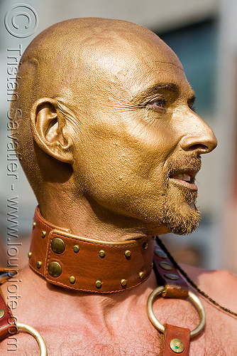 golden face paint, bald, collar, costume, leather, makeup, man