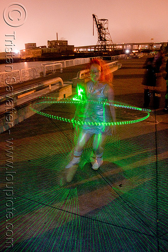 green laser hulahoop - superhero street fair (san francisco), green laser, islais creek promenade, laser hoop, laser hula hoop, night, superhero street fair, woman