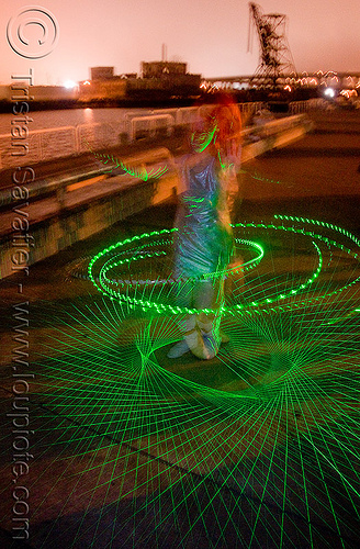 green laser hulahoop - superhero street fair (san francisco), green laser, islais creek promenade, laser hoop, laser hula hoop, night, superhero street fair, woman