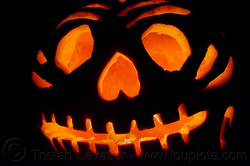 halloween carved pumpkin lit up with candle, backlight, candle light, carved pumpkin, glowing, halloween, orange color, teeth