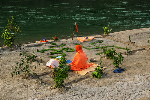 hindu devotee meditating - om and swastika symbols (india), baba, beach, ganga, ganges river, garden, grass, hindu, hinduism, man, meditating, meditation, om, orange, rishikesh, sand, sitting, swastika