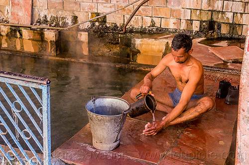 hindu pilgrim bathing at the surya kund pool - yamunotri sacred hot springs (india), bath, bathing, hot springs, men, metal bucket, pool, sitting, surya kund, yamunotri