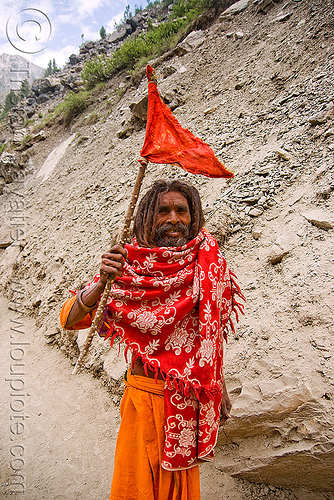 hindu pilgrim with red flag on trail - amarnath yatra (pilgrimage) - kashmir, amarnath yatra, beard, bhagwa, flag, hindu pilgrimage, hinduism, kashmir, mountain trail, mountains, old man, pilgrim, saffron color, stick