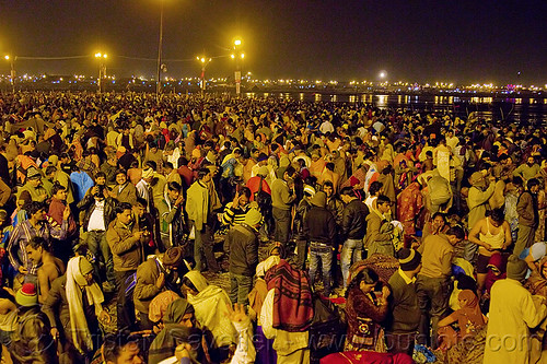 hindu pilgrims gathering at sangam for the holy bath in the ganges river - kumbh mela 2013 (india), crowd, hindu pilgrimage, hinduism, india, maha kumbh mela, men, night, paush purnima, pilgrims, street lights, triveni sangam, women