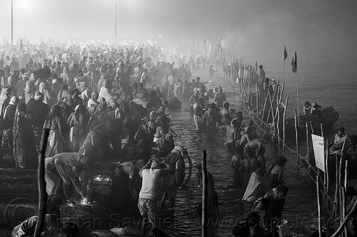 hindu pilgrims having holy bath in the ganges river at the sangam - kumbh mela (india), bathing pilgrims, crowd, fence, ganga, ganges river, hindu pilgrimage, hinduism, holy bath, holy dip, kumbh maha snan, kumbh mela, mauni amavasya, nadi bath, night, river bank, river bathing, river boats, triveni sangam