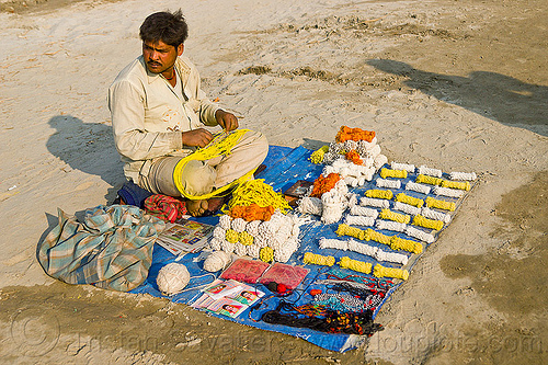 hindu sacred threads (ritual ropes) - india, hindu pilgrimage, hinduism, kumbh mela, man, ritual ropes, rope bundles, sacred thread, sitting, stall, street market, street seller, street vendor, yajno pavitam