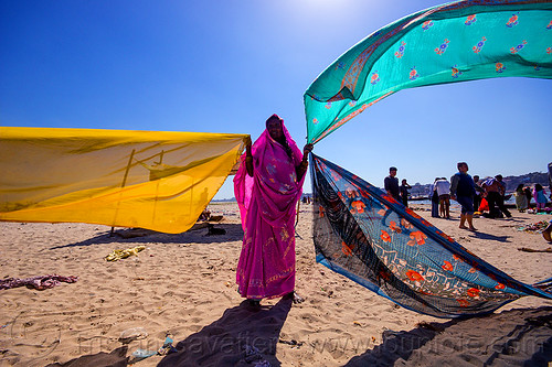 hindu woman drying saris in the wind after holy bath in the ganges river - varanasi (india), beach, drying, indian woman, river bank, sand, saree, sari, varanasi, wind