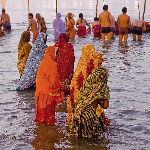 hindu women bathing  in the ganges river at sangam - kumbh mela 2013 (india), bathing pilgrims, dawn, ganga, ganges river, hindu pilgrimage, hinduism, holy bath, holy dip, kumbh mela, men, nadi bath, paush purnima, ritual bath, river bathing, saree, triveni sangam, women