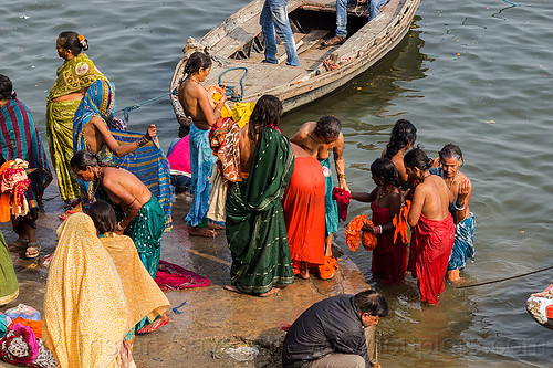 hindu women bathing in the ganges river in varanasi (india), bathing pilgrims, ganga, ganges river, ghats, hindu, hinduism, holy bath, holy dip, nadi bath, river bank, river bathing, river boat, sarees, saris, varanasi, women