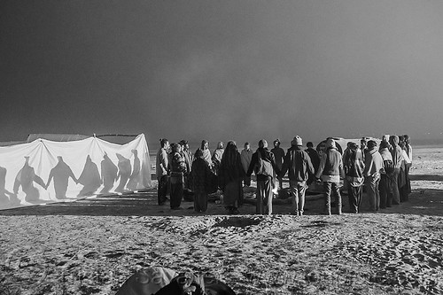 hippies in supper circle at the rainbow camp - kumbh mela 2013 (india), campfire, camping, hindu pilgrimage, hinduism, hippie, holding hands, kumbh mela, night, rainbow camp, supper circle, tents