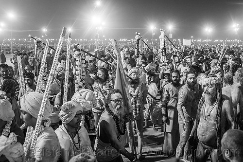 huge crowd of hindu devotees gathers before dawn near the ganges - kumbh mela 2013 (india), crowd, dawn, flower necklaces, hindu pilgrimage, hinduism, holy ash, kumbh mela, marigold flowers, men, naga babas, naga sadhus, night, sacred ash, sadhu, triveni sangam, vasant panchami snan, vibhuti, walking