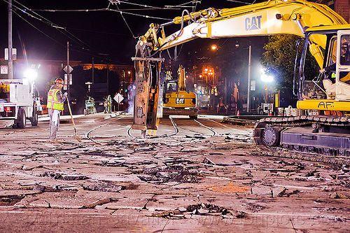 hydraulic jackhammer breaks street concrete, at work, demolition, excavator, high-visibility jacket, high-visibility vest, hydraulic jackhammer, jackhammer attachment, light rail, man, muni, night, ntk, railroad construction, railroad tracks, railway tracks, reflective jacket, reflective vest, safety helmet, safety vest, san francisco municipal railway, track maintenance, track work, worker, working