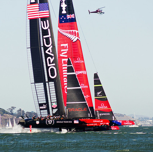 hydrofoil sailboats - neck and neck, ac72, advertising, america's cup, bay, boats, emirates team new zealand, fast, foiling, helicopter, hydrofoil catamarans, hydrofoiling, oracle team usa, race, racing, sailboat, sailing hydrofoils, ships, speed, sponsors