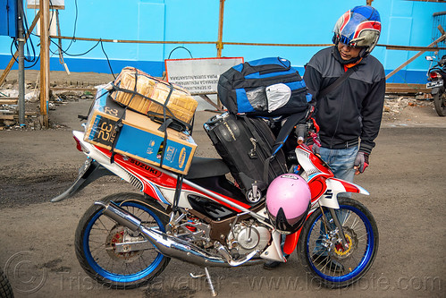 indonesian man with his overloaded motorbike, dock, harbor, motorcycle, surabaya