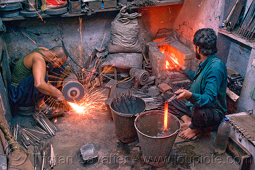 iron grinding and quenching in a blacksmith workshop (delhi), blacksmith, delhi, file tools, furnace, grinding, ironwork, men, metalwork, metalworking, quench hardening, quenching process, rasp tools, red hot, sparks, workers, workshop