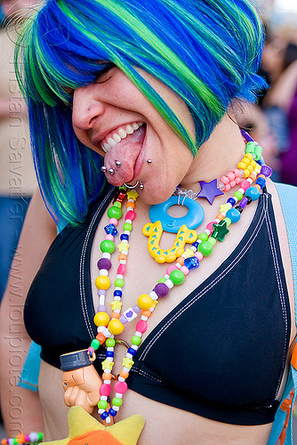 kandi raver with mouth piercing - blue wig, beads, blue wig, kandi kid, kandi raver, lip piercing, necklaces, rave fashion, sticking out tongue, sticking tongue out, tongue piercing, woman
