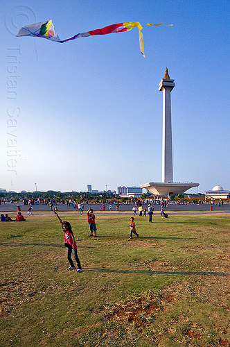 kid flying a kite near the national monument (monas) in jakarta, architecture, children, column, eid ul-fitr, flying, girl, jakarta, kids, kite, lawn, medan merdeka, merdeka square, monumen nasional, national monument, park