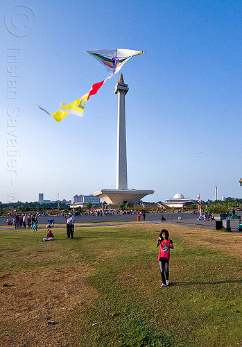 kid flying a kite near the national monument (monas) in jakarta, architecture, child, column, eid ul-fitr, flying, girl, jakarta, kid, kite, lawn, medan merdeka, merdeka square, monumen nasional, national monument, park