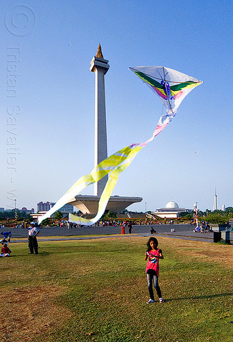 kid flying a kite near the national monument (monas) in jakarta, architecture, child, column, eid ul-fitr, flying, girl, jakarta, kid, kite, lawn, medan merdeka, merdeka square, monumen nasional, national monument, park