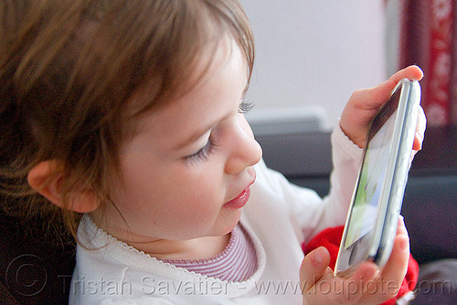 kid playing a video game on an iPhone, cellphone, child, iphone, kid, little girl, playing, video game