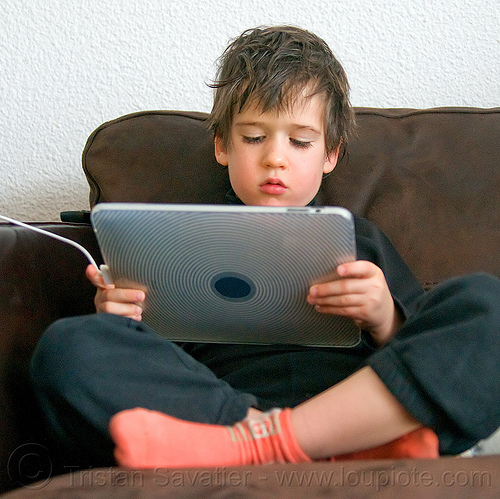 kid playing video game on ipad, boy, child, coach, cross-legged, ipad, kid, playing, sitting, tablet computer, video game