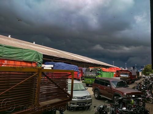 line of trucks, car and motorbikes waiting to board the ferryboat, cars, clouds, cloudy, dock, ferry, ferryboat, harbor, makassar, motorcycles, stormy, trucks
