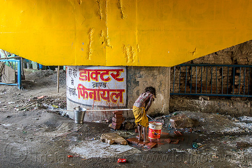 little girl filling-up plastic bucket at water hose, bridge pillar, child, daraganj, hindu pilgrimage, hinduism, kid, kumbh mela, little girl, metal bucket, plastic pipe, plastic piping, steel bucket, water hose, water pipe