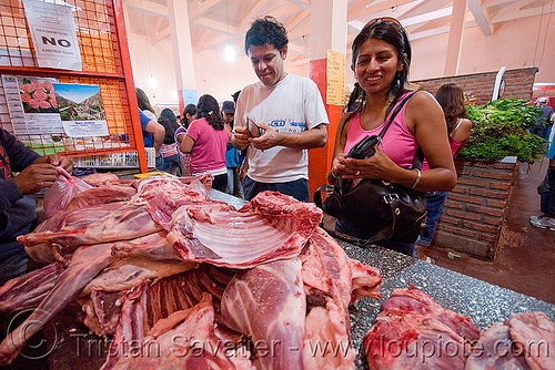 llama meat at meat market, argentina, llama meat, man, meat market, meat shop, noroeste argentino, quebrada de humahuaca, raw meat, tilcara, woman