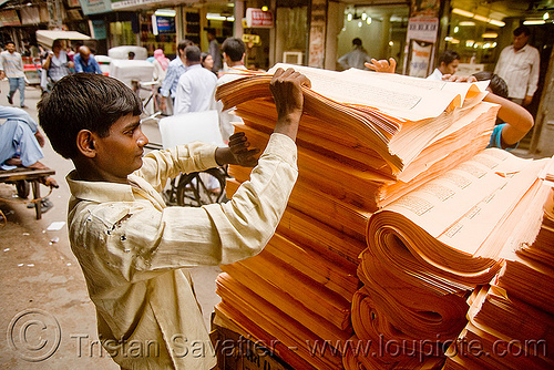 loading sheets of printed paper onto a cycle rickshaw (india), delhi, jayyed press, men, print shop, printed paper, printed sheets, printing shop, tibetan prayers, workers