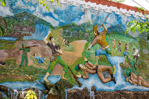 low-relief mural with indigenous people killing european soldiers (indonesia), battle, indigenous, killing, low relief, monument, mural, painting