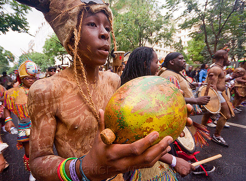 macara player - choukaj at the carnaval tropical de paris, caribbean, carnaval tropical, choukaj, costumes, creole, créole, guadeloupe, indigenous culture, macara, man, music player, parade, percussion, percussionist, playing, shaking, traditional, tribal, west indies