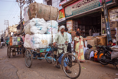 man walking cargo tricycle with heavy load of freight (india), bags, cargo tricycle, cargo trike, freight tricycle, freight trike, heavy, load bearer, man, moving, sacks, transport, transportation, transporting, varanasi, walking, wallah