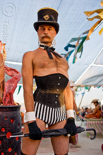 man with corset, bow tie, corset, dickie bow, fashion show, man, mustache, randal smith, stovepipe hat, umbrella