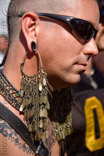 man with large brass earring - dore alley fair (san francisco), brass, ear piercings, earlobe stretched piercing, gauging, jewelry, large earring, man, sunglasses