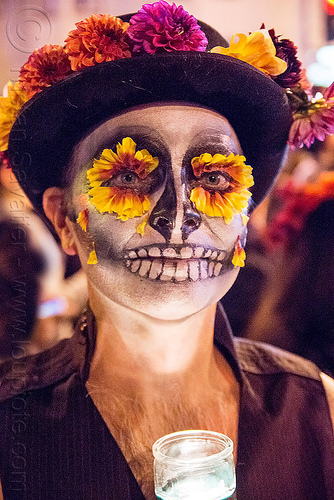 man with marigold flowers eyes and sugar skull makeup - dia de los muertos, day of the dead, dia de los muertos, eye makeup, face painting, facepaint, flower hat, flower makeup, flowers, glass candle, halloween, man, marigold, night, sugar skull makeup