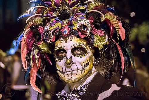 man with sugar skull makeup - large feather headdress - dia de los muertos, bindis, day of the dead, dia de los muertos, face painting, facepaint, feather headdress, feathers, halloween, man, night, sugar skull makeup