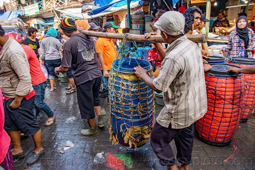 men carrying large container with bamboo stick, carrying, crowd, fish market, men, pasar pabean, seafood, surabaya