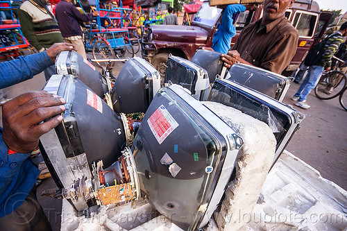 men examining crt screens (india), cathodic ray tubes, crt, delhi, electronics, men, recycling, styrofoam, television, tv screens