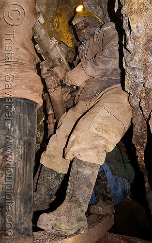 mine worker with drill, bolivia, cerro rico, compressed air, drilling, fuses, fuzes, man, mina candelaria, mine tunnel, mine worker, miner, mining, potosí, power drill, respirator, rubber boots, safety helmet, underground mine