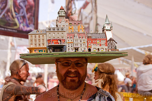 miniature city block hat, beard, buildings, city block, cityscape, eyeglasses, eyewear, hat, headdress, houses, man, miniature, model, prescription glasses, spectacles