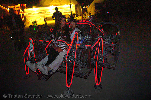 mondo spider with passenger - burning man 2006, art car, biomimicry, burning man art cars, burning man at night, el-wire, electroluminescent wire, glowing, mechanical spider, motorized spider, mutant vehicles, walker, walking machine