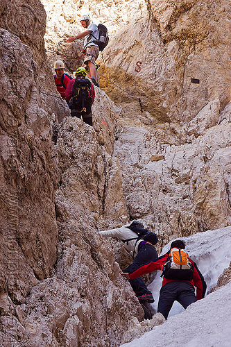 montaineers ascending the santner pass via ferrata in the dolomites, alps, climbers, climbing helmet, dolomites, dolomiti, ferrata santner, mountain climbing, mountaineer, mountaineering, mountains, old snow, rock climbing, via ferrata del passo santner
