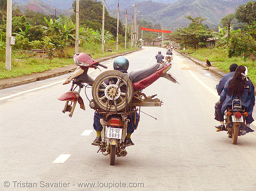 motorbike carrying another motorbike - vietnam, cargo, freight, loaded, motorcycles, rider, riding, road, underbone motorcycle