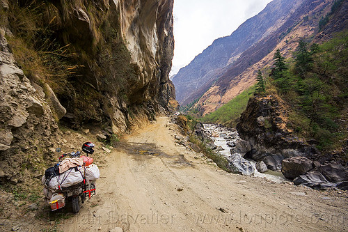 motorbike on road between tatopani and jomsom (nepal), annapurnas, bags, cliff, dirt road, kali gandaki river, kali gandaki valley, luggage, motorcycle touring, mountain road, mountains, sacks, stream, unpaved
